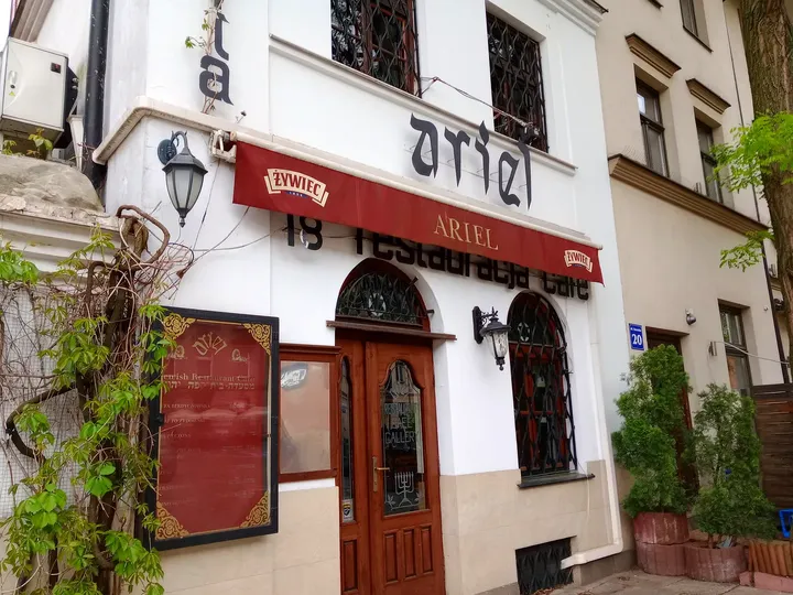 Signs above an arched entrance at Szeroka Street