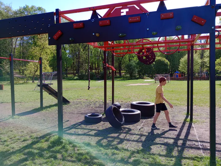 Workout frame above the paved surface at Tysiąclecia Park outdoor exercise ground
