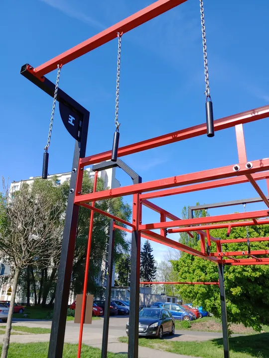 Tall exercise station beneath the blue sky at Tysiąclecia Park outdoor exercise ground