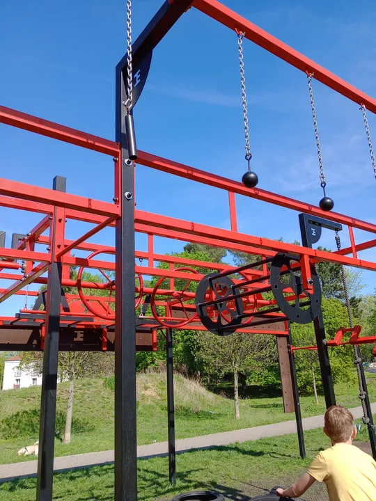 Red ladder and hanging grips at Tysiąclecia Park outdoor exercise ground
