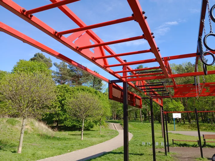 Exercise frame seen across the grass at Tysiąclecia Park outdoor exercise ground