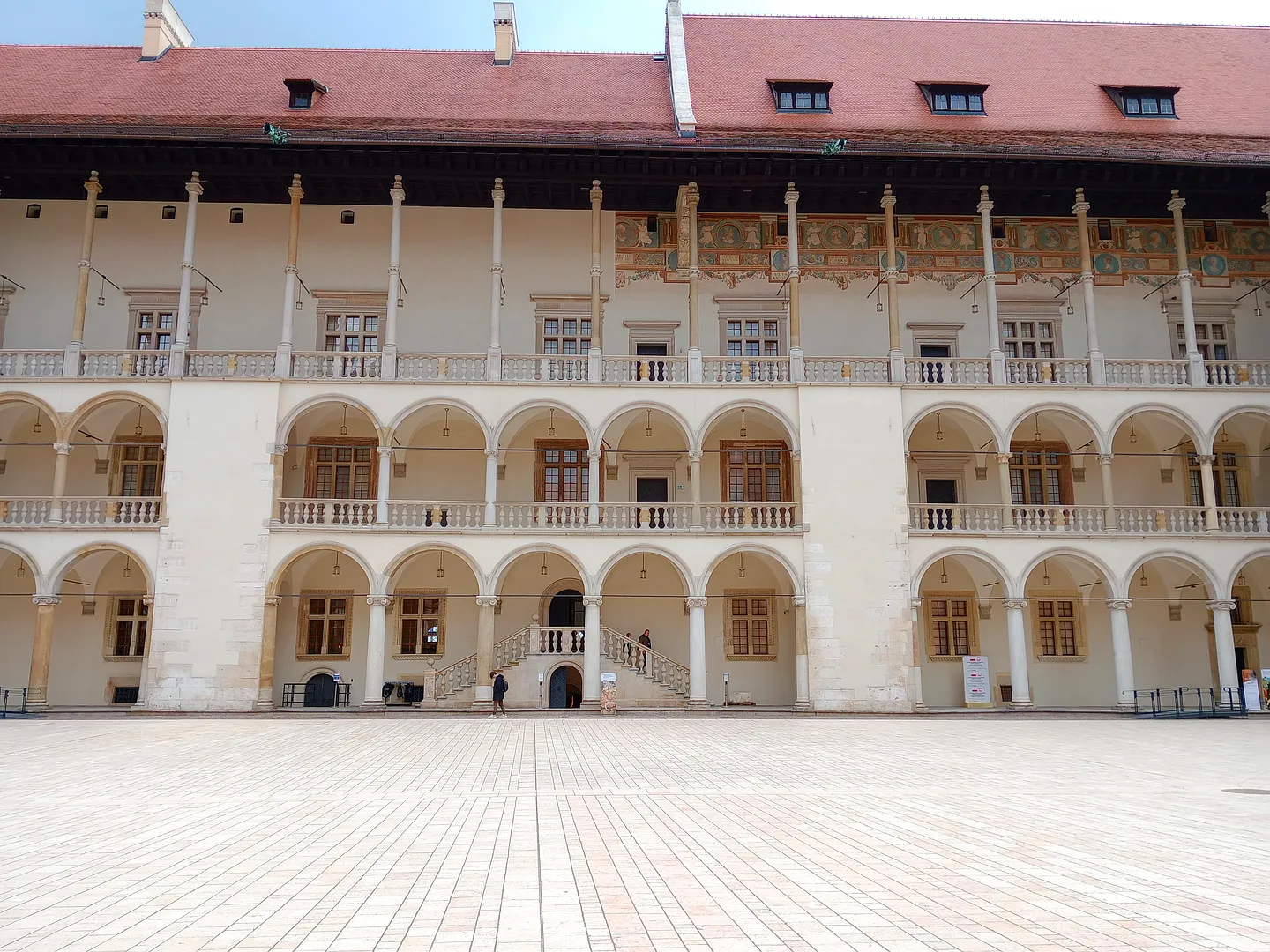 Rows of pale arches surround Wawel’s courtyard on Wawel Hill in Kraków