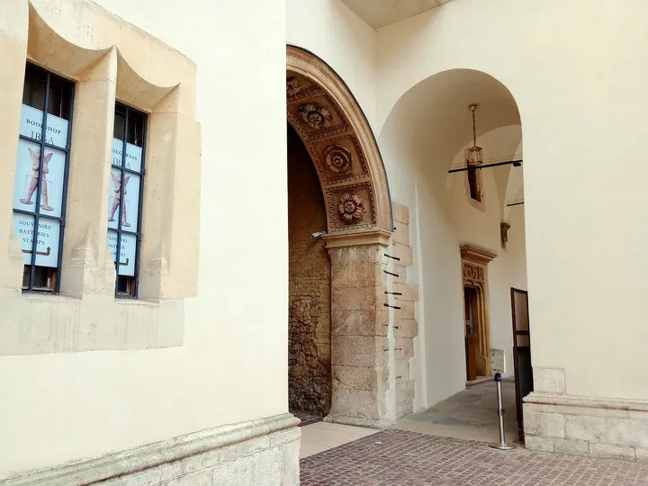 Carved stone around an arch and a window reward a closer look along the walkway on Wawel Hill in Kraków