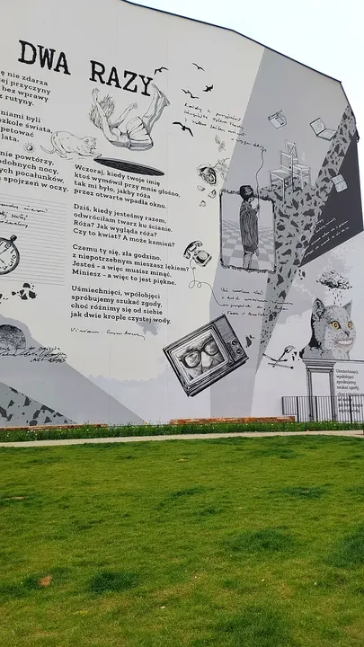 Poem wall above the planted bed at Wisława Szymborska Park
