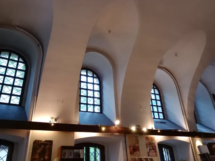 High windows beneath the vaulted ceiling at Wolf Popper Synagogue and Austeria