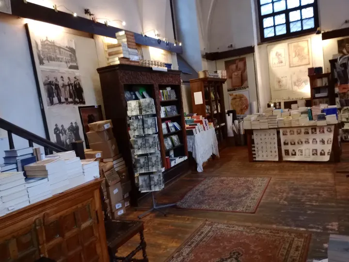 A display table beside the shelves at Wolf Popper Synagogue and Austeria