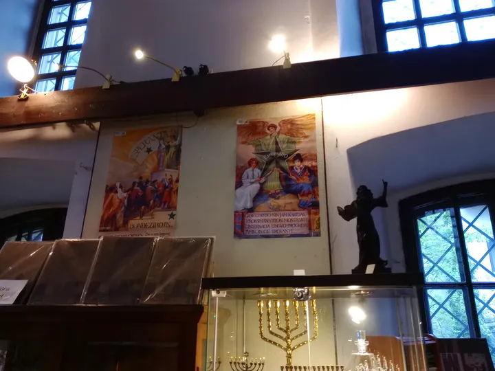 Books displayed near a window at Wolf Popper Synagogue and Austeria