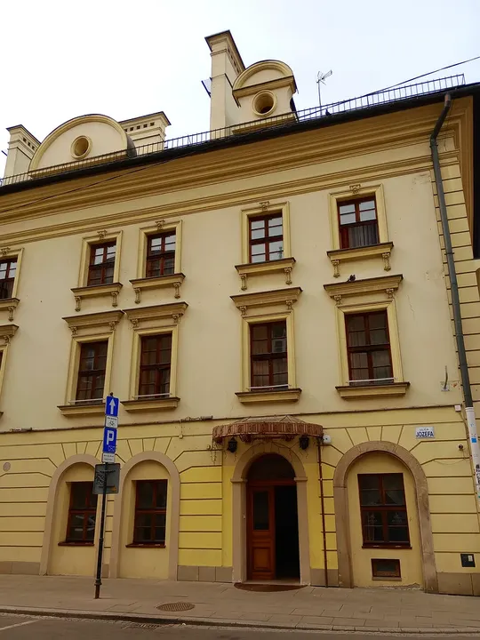 Stone decoration above a townhouse doorway at Wolnica Square