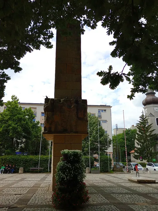 Memorial framed by the nearby canopy at World War II memorial, Zielona Góra