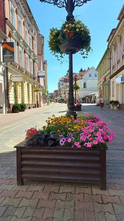 Flowers beneath a streetlamp on the town walk at Zielona Góra Old Market Square