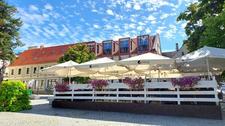 Outdoor tables under parasols at Zielona Góra Old Market Square