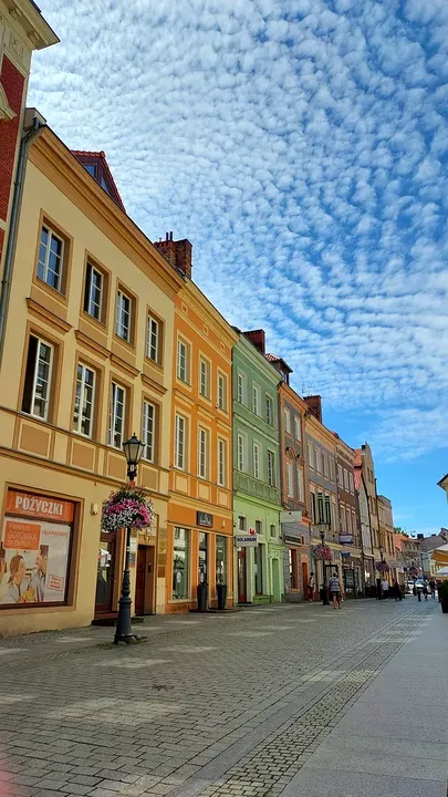 Colourful frontages beneath the summer sky at Zielona Góra Old Market Square