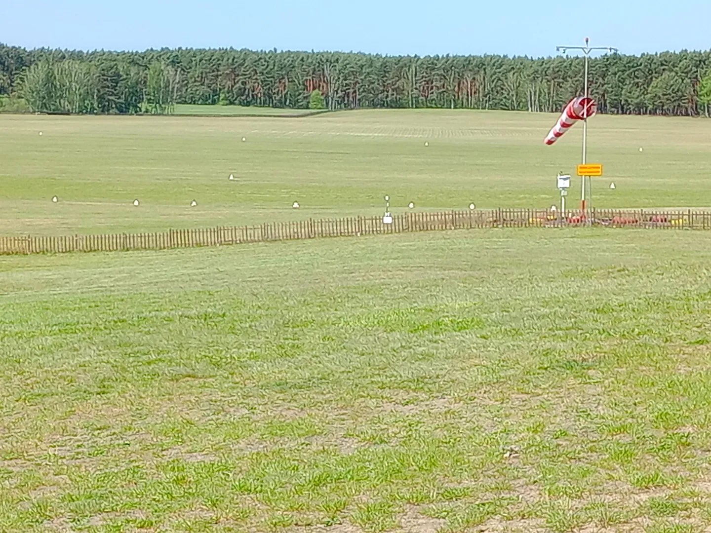 The windsock over the grass at Zielona Góra–Przylep airfield