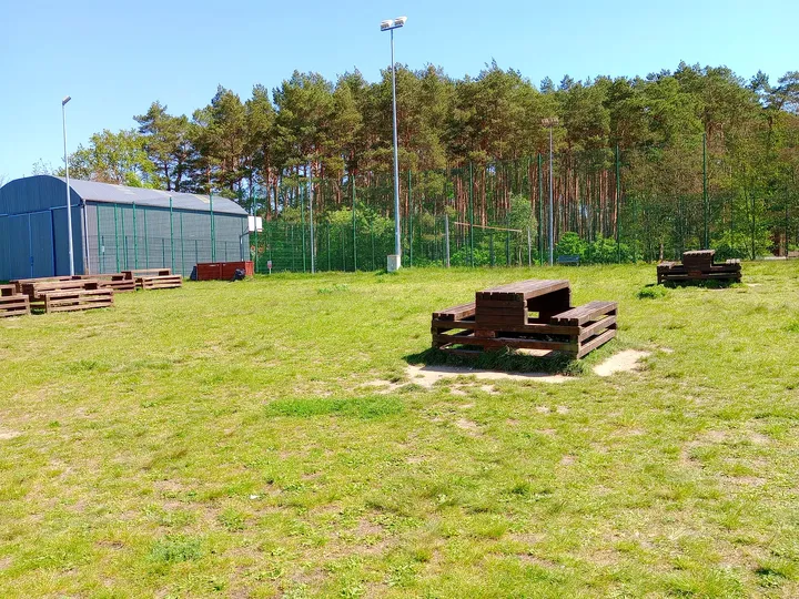 A hangar and outdoor seating at Zielona Góra–Przylep airfield
