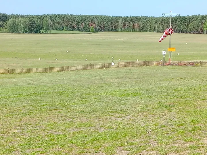 The windsock over the grass at Zielona Góra–Przylep airfield