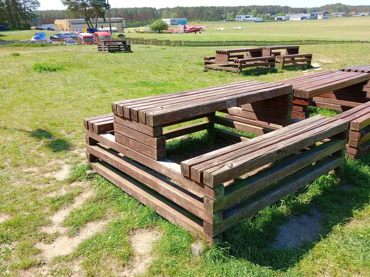 Wooden picnic seating at Zielona Góra–Przylep airfield
